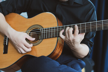 Fototapeta na wymiar close up view of musician playing guitar