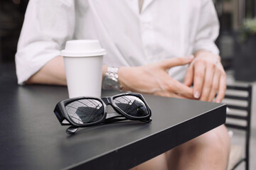 Sunglasses on a table outside coffee shop