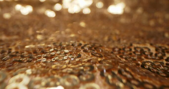abstract textile background. detailed extreme close-up of gold sequins on fabric