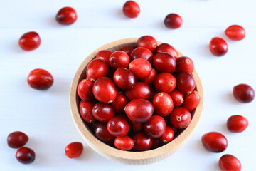 Red, fresh cranberries in a wooden bowl