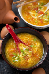 Middle close-up of chinese tomato egg-drop soup served in a pair of bowls, vertical shot, selective focus
