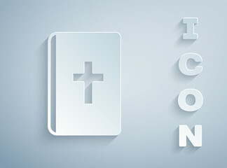 Paper cut Holy bible book icon isolated on grey background. Paper art style. Vector