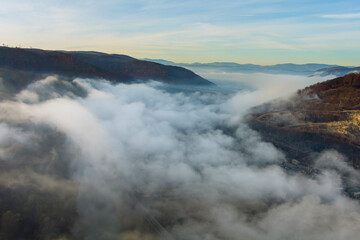 Misty foggy mountain landscape with autumn forest