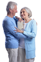 Happy senior couple embracing and posing on white background