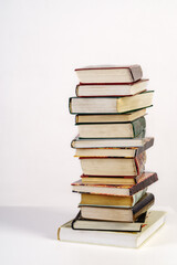 Stack of old books on white background