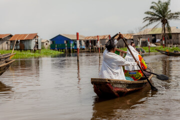 Woman rowing in Ganvié, Benin on Lake Nokoue. 