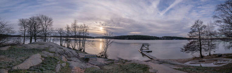 Panorma view at the lake M&auml;laren a Pale Winter solstice day, cliffs, jump tower and trees in the district Bromma in Stockholm