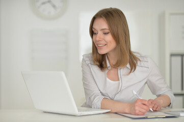  young business woman   with laptop in office