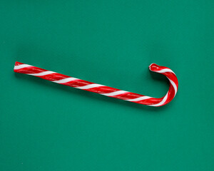 Candy cane over green background