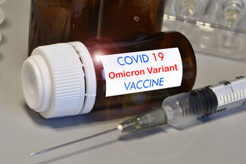 Covid-19 Omicron variant strain vaccine. Syringe and vaccine. Treatment for coronavirus covid-19.