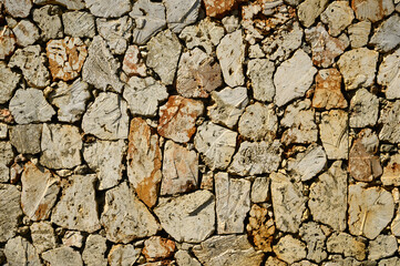 Fence of caliche stone pattern. Rock texture.