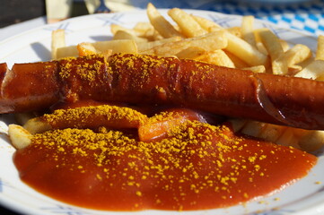 delicious hot fried German currywurst with crispy french fries and curry sauce 