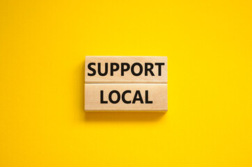 Time to support local symbol. Wooden blocks with words 'Support local'. Beautiful yellow background. Business and time to support local concept. Copy space.
