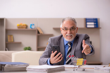 Old male employee in e-commerce concept during pandemic