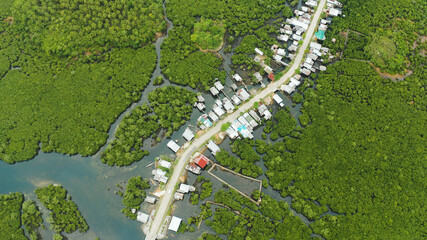 The village and the highway among the mangroves from above. Siargao island, Philippines.