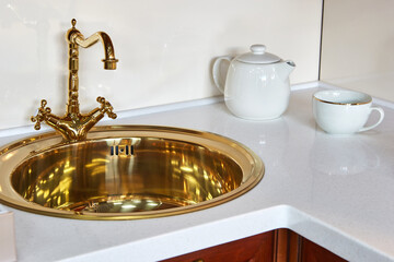 Fototapeta na wymiar golden vintage luxury faucet with kitchen sink