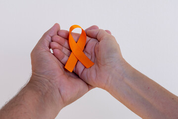 December orange	. man and woman holding orange ribbon. campaign to prevent skin cancer, melanoma.