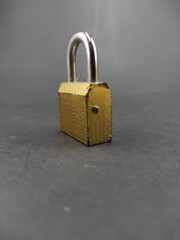 Fototapeta premium Photo of golden padlock isolated on black background, Not Focus