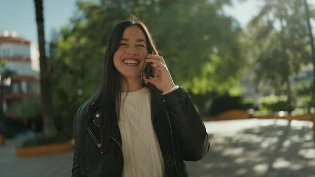 Young hispanic woman smiling confident talking on the smartphone at park