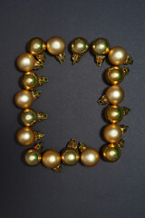 Top view of frame from golden christmas balls.