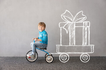 Happy child riding bike. Christmas holiday concept