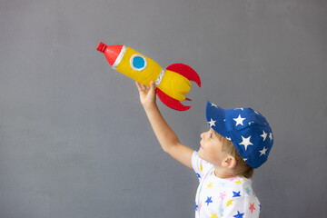 Happy child playing toy rocket