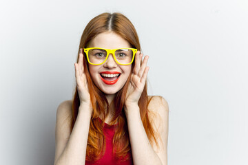 Naklejka premium emotional woman in yellow glasses red lips attractive look