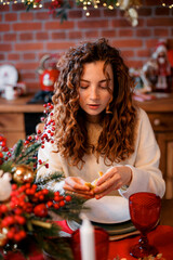 A beautiful red-haired girl portrait in a Christmas interior. Christmas theme. Cozy atmosphere. Christmas tree, decorated fireplace, lots of gifts, 