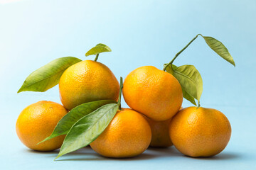 tangerines piled up on a blue background