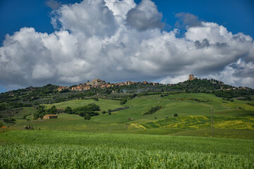 Fototapeta na wymiar Tuscany, italy, may 2018, ancient city in the distance on top of a green hill