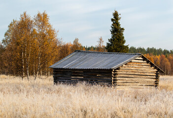 An old traditional hay shed on the meadow in Finnish countryside
