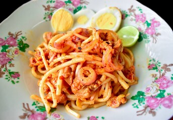 Myanmar traditional thick round noodle salad called Nan Gyi Thohk recipe. Equated as a Burmese version of spaghetti.