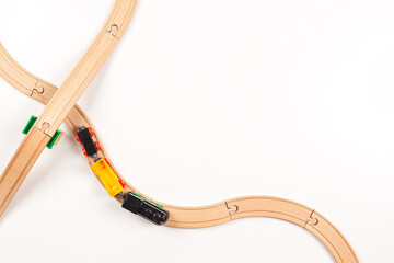 Kid toy train and wooden rails on white background. Top view