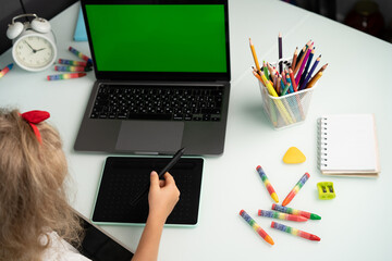 little girl with graphics tablet and laptop, modern schoolchildren, graphic design courses for...