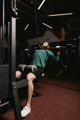 Fototapeta na wymiar Bearded strong man working out in gym doing exercise for back. Strong man doing lat pulldown