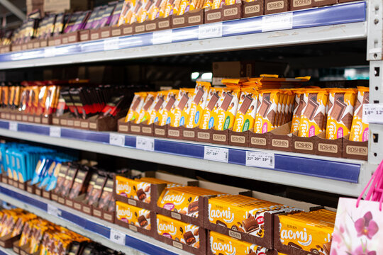 Odessa, Ukraine - November 9, 2021: Shelf with chocolate bars in the assortment of the Roshen brand. Selective focus, shallow depth of field.