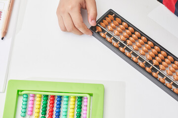 Schoolboy do mental math. Mental mathematics. 8 years old multiracial boy busy with mental...