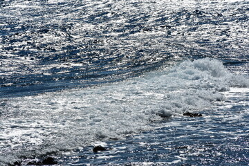 the water surface with the glare of the sun, ripples and waves. Abstract background. Clean water....