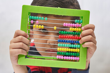 Schoolboy do mental math. Mental mathematics. 8 years old multiracial boy busy with mental...