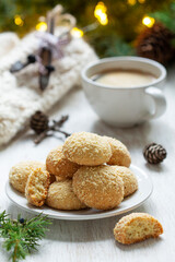 Christmas nut cookies Filbertines served with coffee on a background of Christmas decorations.