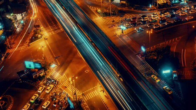 Time lapse of busy highway road junction in metropolis city center at night . Transportation and infrastructure concept .
