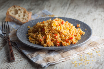 Bulgur with stewed vegetables in a plate. Bulgur with carrots and onions. Naturally low-calorie food.