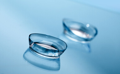 contact lenses on blue background close up view - Image