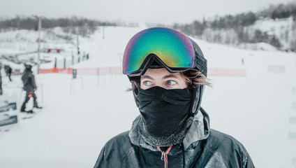 Fototapeta na wymiar Ski portrait. Iced up frozen ski goggles and ski helmet on man looking at camera with ski goggles icing up in freeze. Concept of Glaze ice, also called glazed frost snow when snowboarding or skiing