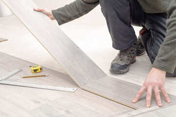  installing new laminated wooden floor. copy space