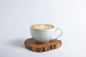 Hot cafe Latte espresso coffee in white ceramic cup on wood saucer with rosetta latte art isolated...