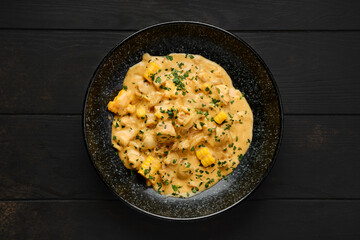 Chicken meat with corn and fried onion covered with creamy sauce