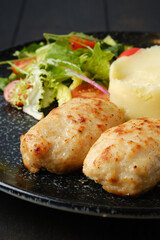 Closeup view of meat cutlet with mashed potato and fresh vegetables