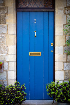 House number 3 on a blue front door