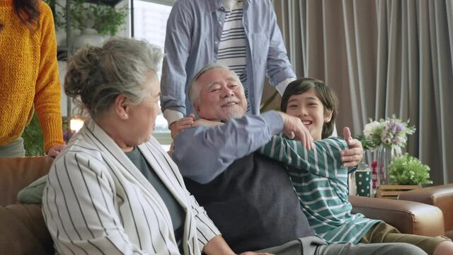 happiness asian multi generation family,grandparent grandchild hug kissing together with love tenderness care giving spent time together three generations people having fun together, sitting on couch